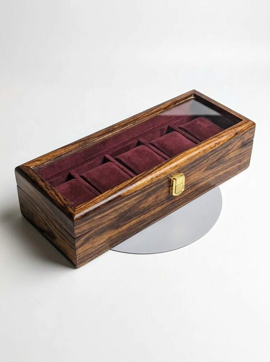 Wooden watch box with velvet interior on a white background