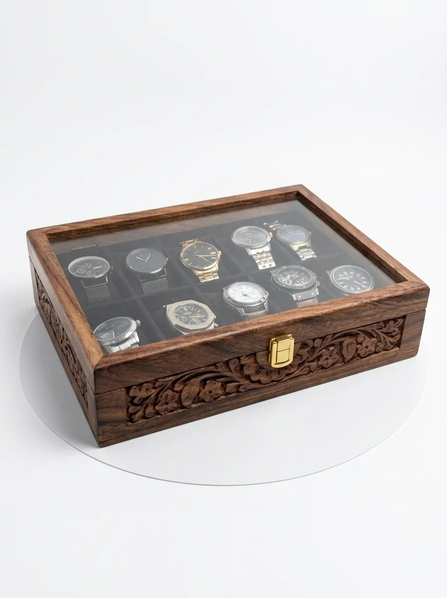 Wooden watch display case with glass top containing multiple watches on a white background