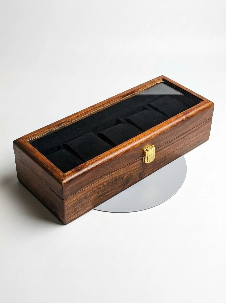 Wooden watch box with glass lid on a white background